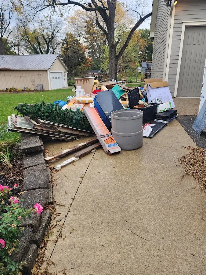 Dumpster being loaded with debris for Commercial Dumpster Rental in New Baden